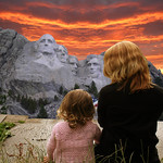 Mother and daughter chat in front of the Mount Rushmore National Memorial