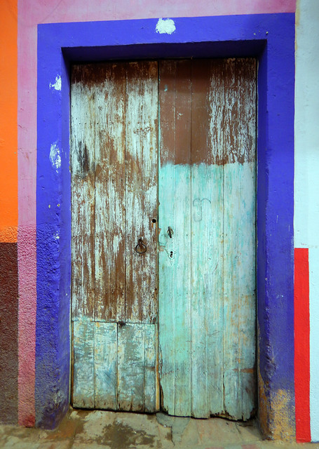 Bright wall with a blue door in Talpa, one of Mexico's Pueblos Magicos in the Pacific high sierras