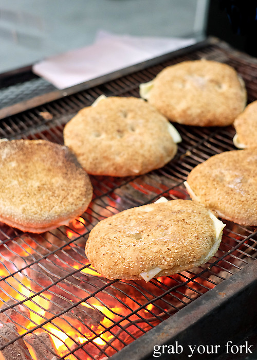 Sesame kaak with the haloumi cheese on the charcoal barbecue at the Ramadan food festival in Lakemba Sydney