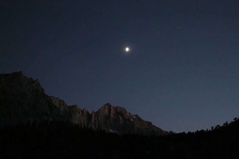 The moon is setting over University Peak as we hike up the Kearsarge Pass Trail in the evening. Little Pothole Lake is below the photo, shrouded in darkness.