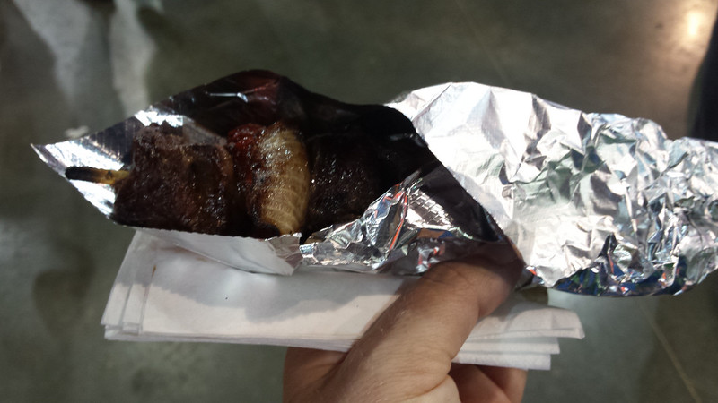 meat and onions on a stick, wrapped in aluminum foil