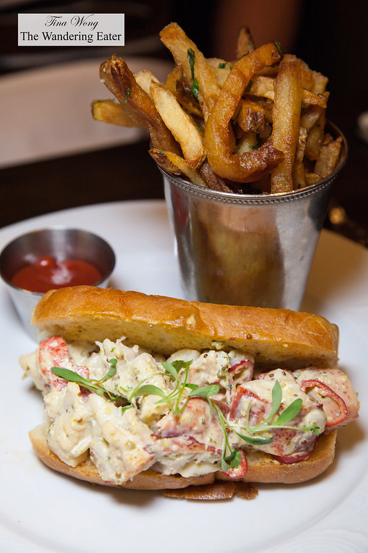 Lobster roll with melted butter, mayo, tarragon on buttered roll and side of fries